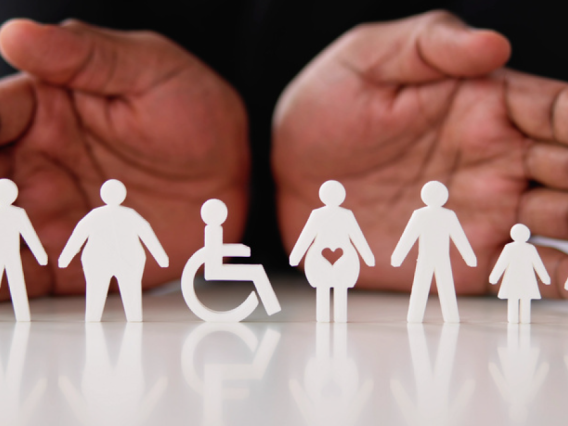 open hands behind silhouetted cutouts of people with disabilities