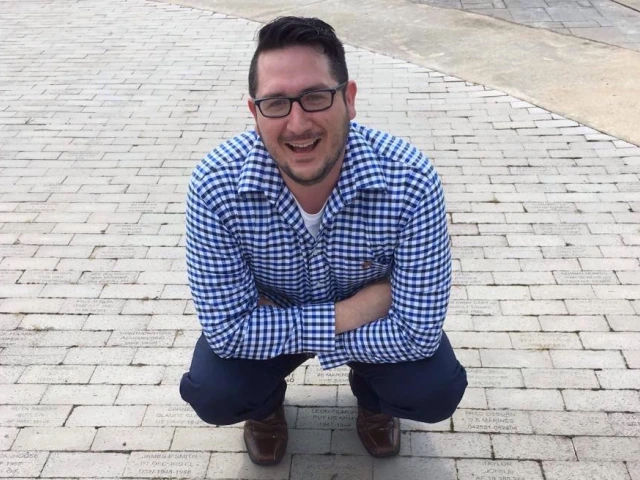 Josh Drywater sitting down smiling