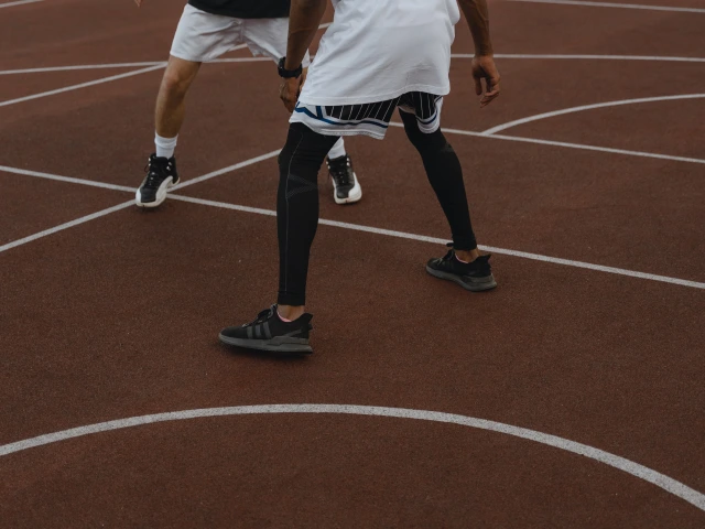 Two people playing basketball.