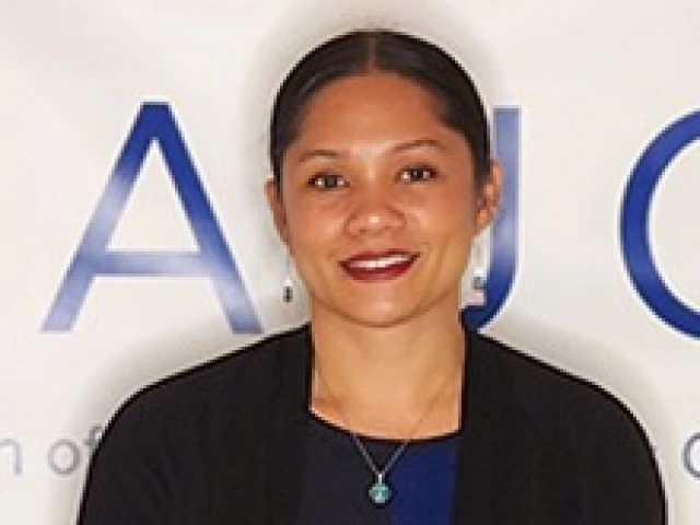 Woman standing while holding a square, glass award