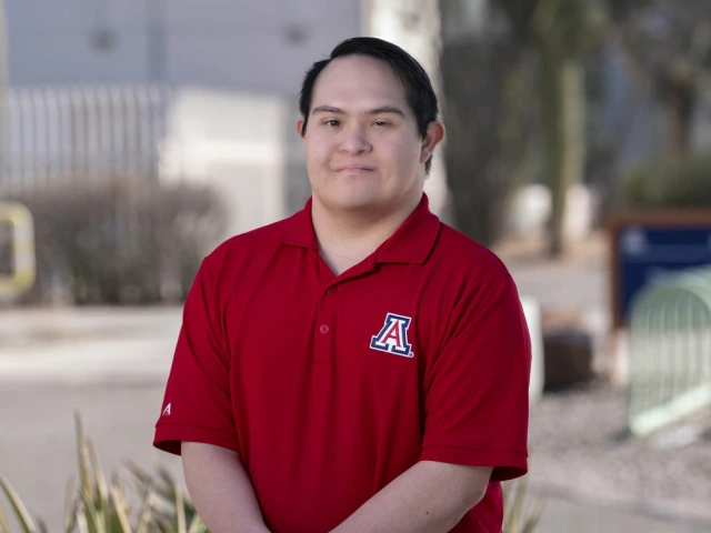 Hispanic man wearing a red polo