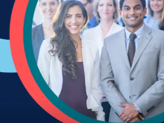 A group of individuals dressed in formal attire smiling at the camera.