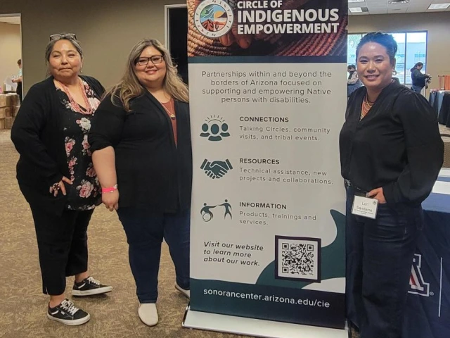 Left to right: Agnes Attakai, Rosa Rojas-Franco, and Mỹ Lê Sandaine stand next to a banner for the Circle of Indigenous Empowerment