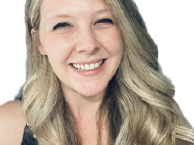 woman with long blonde hair and she is smiling at the camera