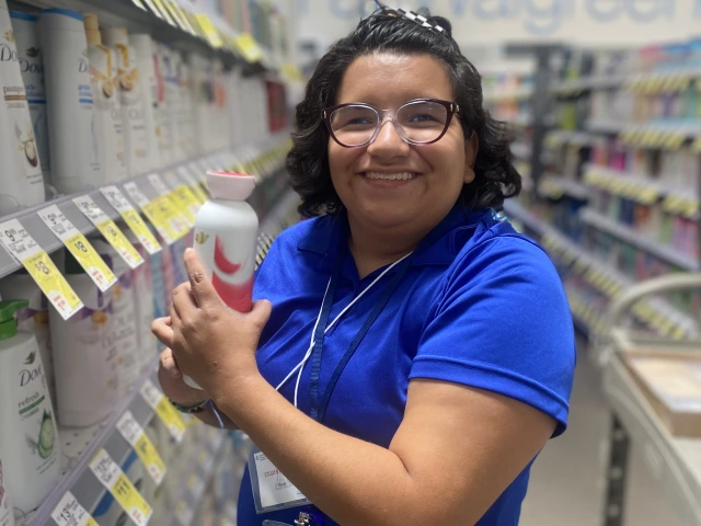 woman wearing a blue shirt and is smiling at the camera
