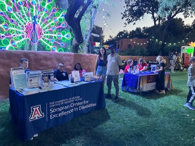 The Sonoran Center table at Dream Night, lit by a peacock-style light fixture
