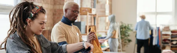 Woman with Dreadlocks Sorting Clothes