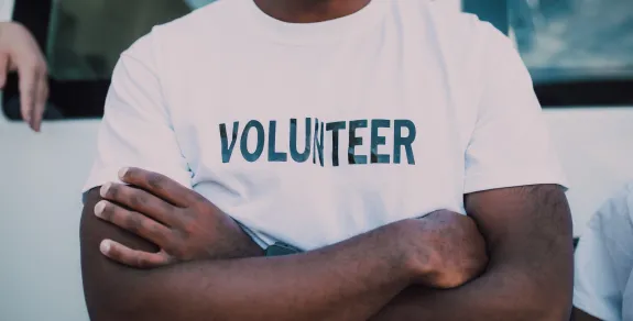 Crossed-arms man in a volunteer Tshirt