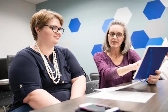 2 women siting and talking 