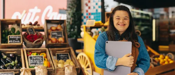 Woman with Down Syndrome working at a market.