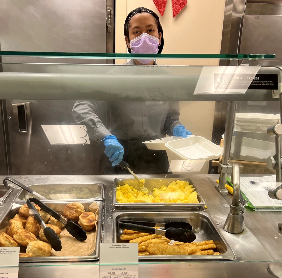 Young person working a buffet station