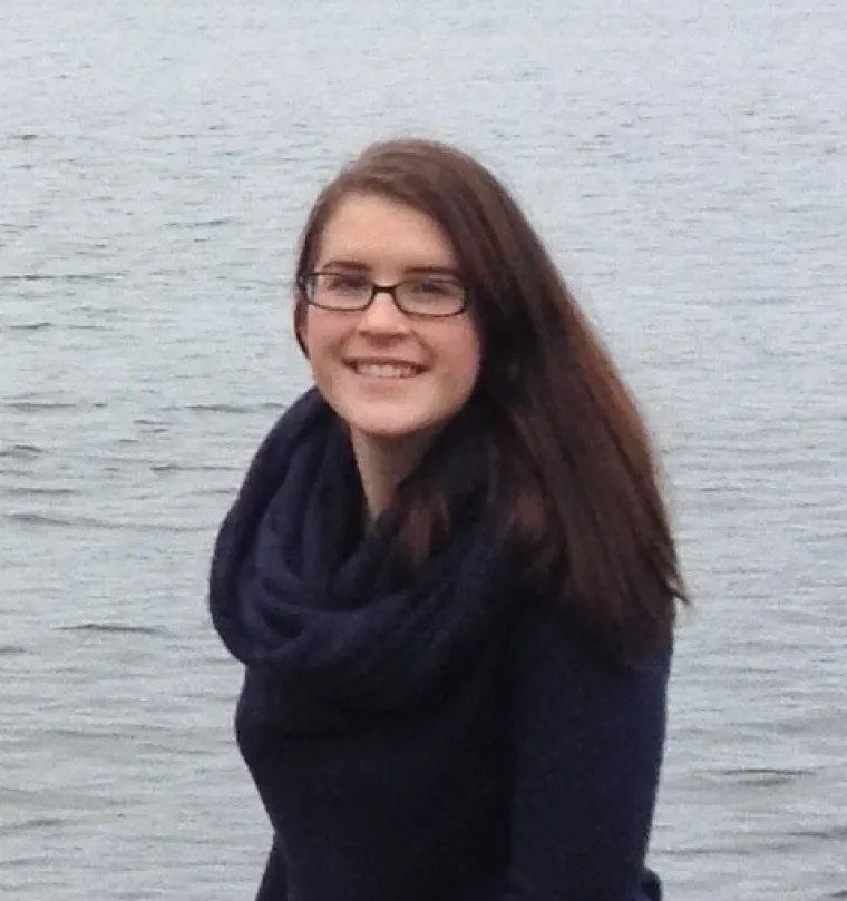 Casey, a long hair woman with glasses smiling