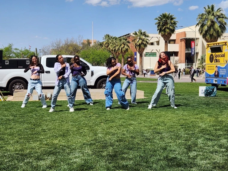 DiaClones in formation crossing their arms during their dance performance. 