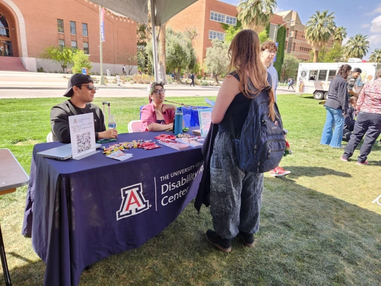 The University of Arizona Disability Resource Center representatives speaking with attendees.