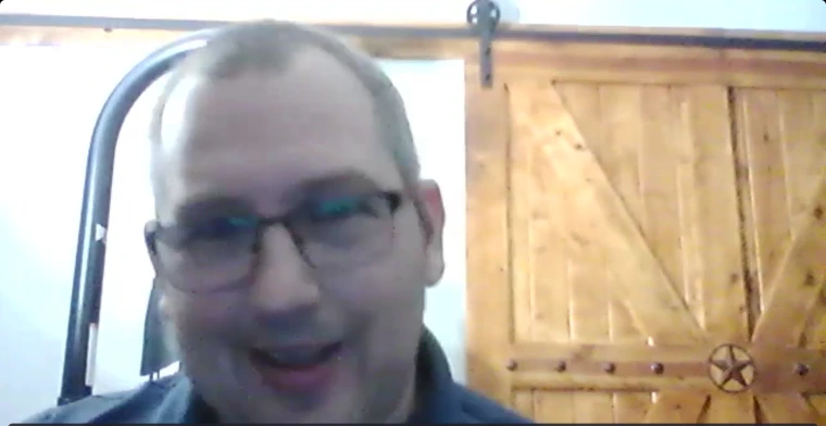 Jason Snead presenting on AZ ABLE accounts. He is seated in front of a wooden door and smiling