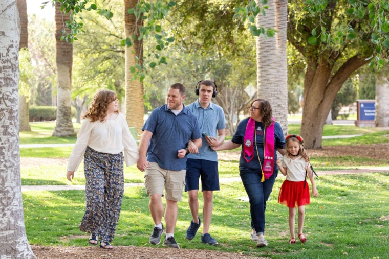 Jennifer Haggerty walking in a park surrounded by her family