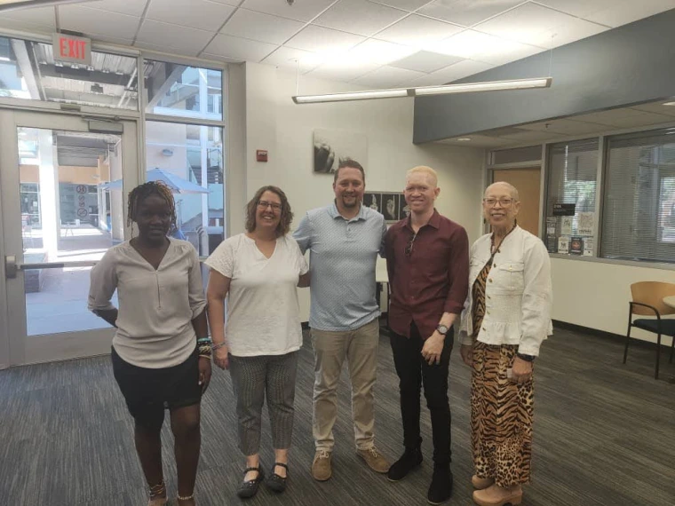 Mai, Kelvin, and Disability Resource Center staff pose for a photo in the DRC.