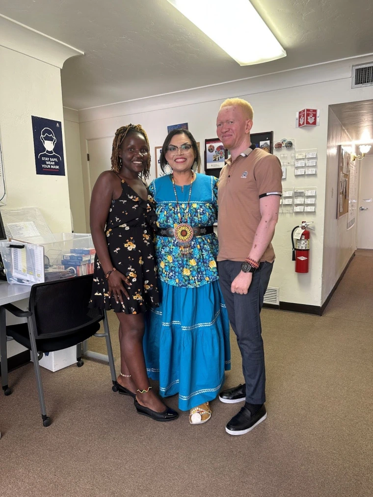 Mai, Kelvin, and Elisa Manuel smiling for a photo in the Sonoran Center office.