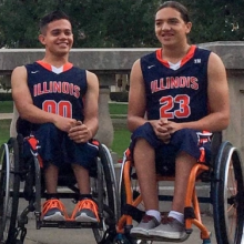 Two basketball players sitting in wheelchairs